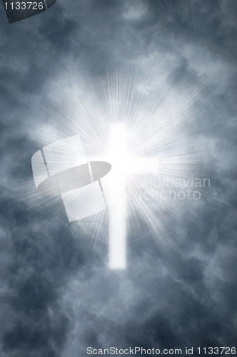 Image of Religious cross shining through clouds