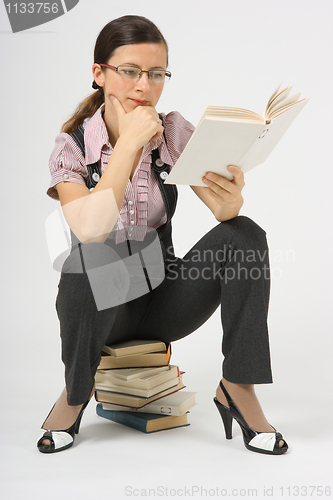 Image of girl in glasses to book