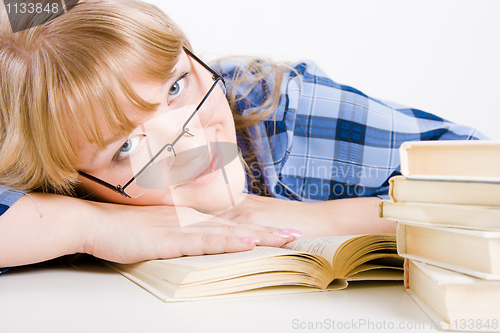 Image of blonde in glasses with books