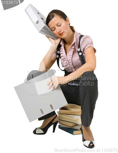 Image of the girl sleeps on the books
