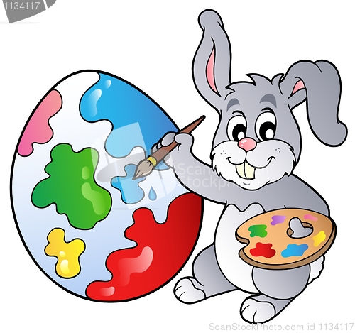 Image of Bunny artist painting Easter egg