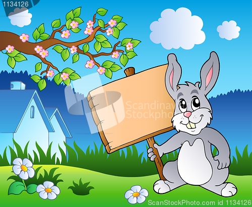 Image of Meadow with bunny holding board