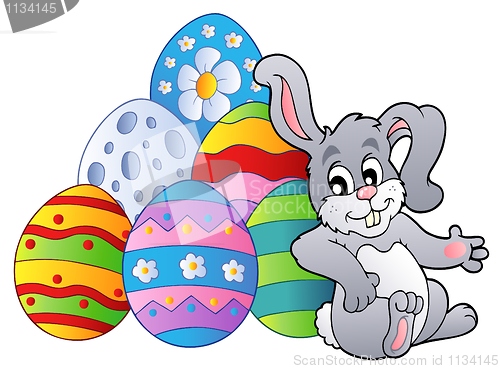 Image of Bunny resting beside Easter eggs