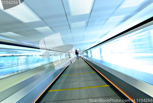 Image of moving escalator with person