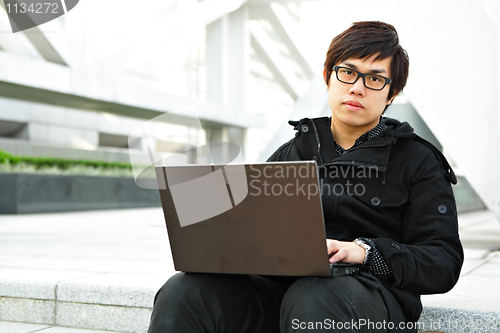 Image of man using computer outdoor