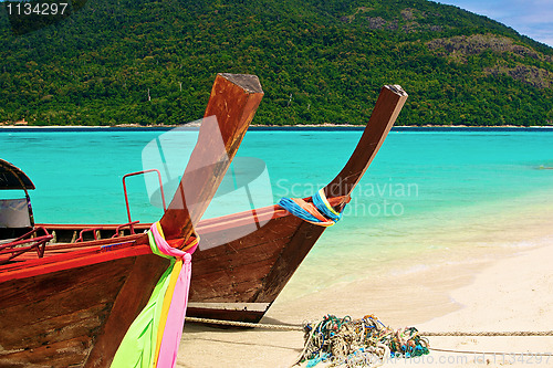 Image of Paradise island and two boats in the green ocean