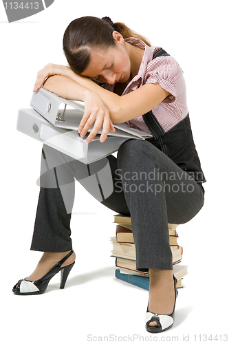 Image of young girl asleep sitting on the books