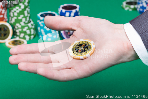 Image of poker chips in the palm of a man