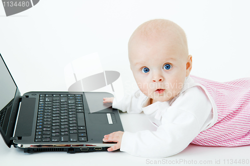 Image of baby with laptop in studio