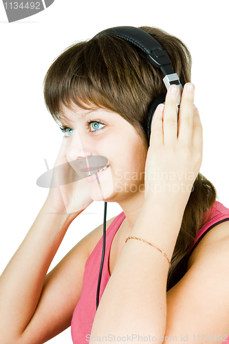 Image of beautiful girl in headphones listens to music