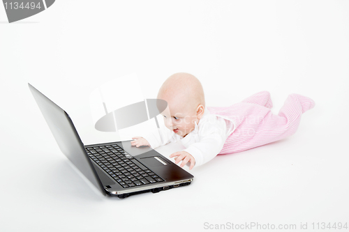 Image of baby playing on the computer