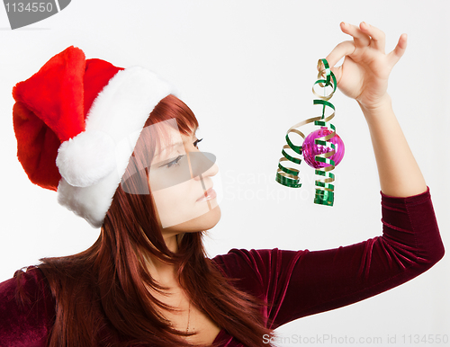 Image of girl in a Christmas hat with a decoration