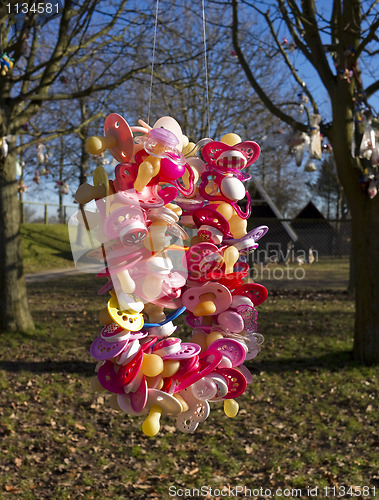 Image of Colorful pacifiers in tree
