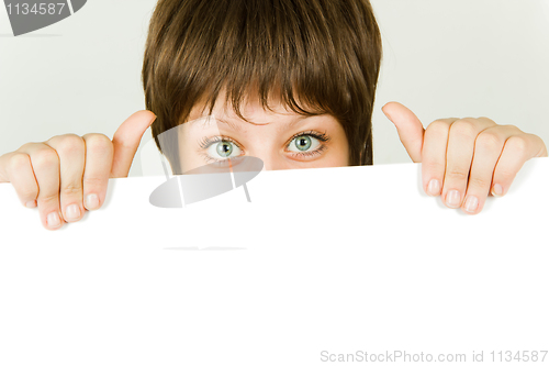 Image of girl hiding behind a white banner