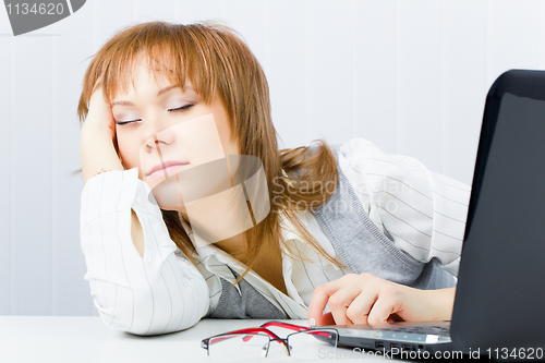 Image of worker, asleep on a laptop
