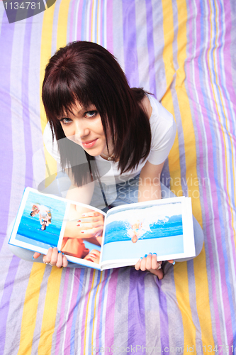 Image of beautiful young woman reading