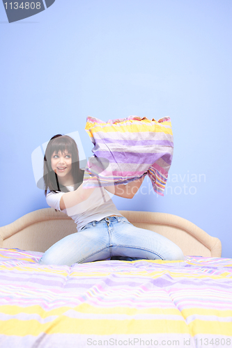 Image of Woman having pillow fight