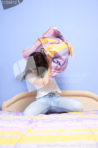 Image of Woman having pillow fight