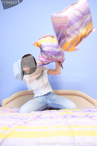 Image of Woman having pillow fight