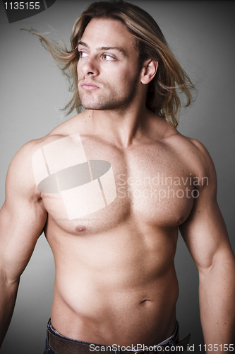 Image of Muscular man measuring his waist