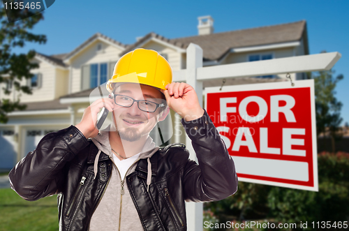 Image of Contractor in Hard Hat in Front of House and Sign