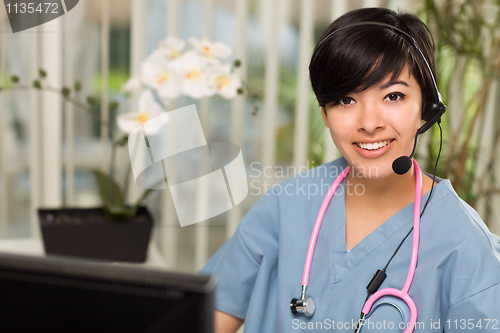 Image of Attractive Multi-ethnic Woman Wearing Headset, Scrubs and Stetho