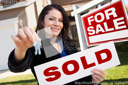 Image of Hispanic Woman Holding Sold Real Estate Sign and Keys in Front H