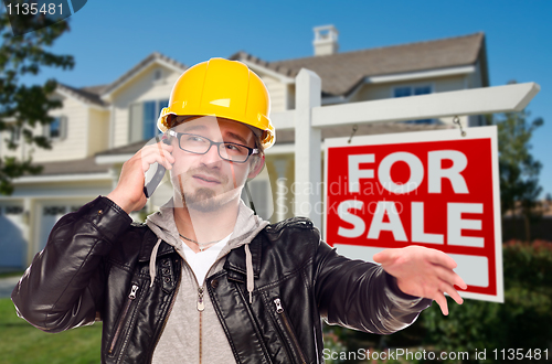 Image of Contractor in Hard Hat in Front of House and Sign