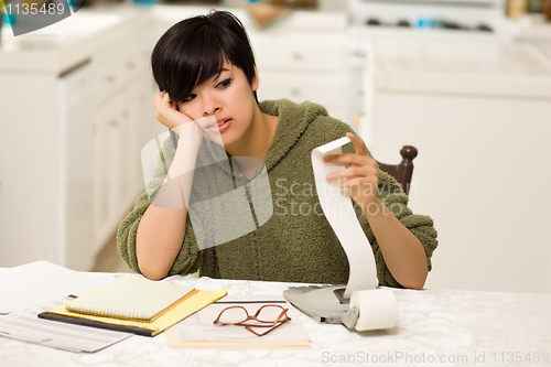 Image of Multi-ethnic Young Woman Agonizing Over Financial Calculations