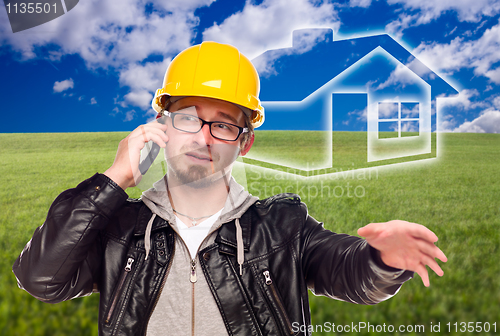 Image of Contractor in Hard Hat in Front of Ghosted House and Grass Field