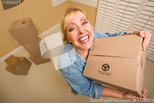 Image of Excited Woman Holding Moving Boxes in Empty Room