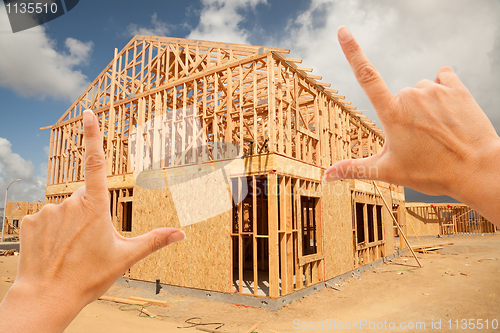 Image of Female Hands Framing Home Frame on Construction Site