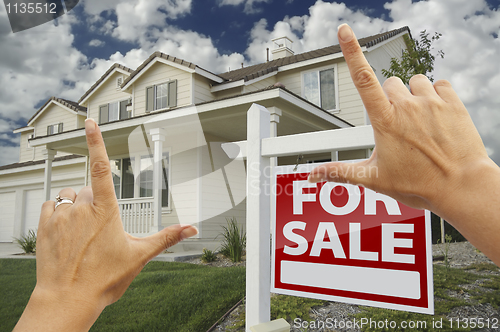 Image of Hands Framing For Sale Real Estate Sign and New House
