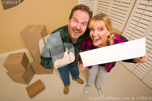 Image of Goofy Goofy Thumbs Up Couple Holding Blank Sign Surrounded by Bo