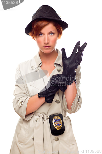 Image of Red Haired Female Detective Putting on Gloves Wearing a Trenchco