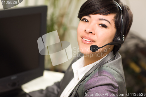 Image of Attractive Young Mixed Race Woman Smiles Wearing Headset