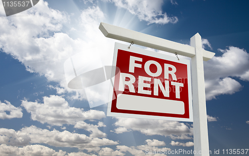 Image of Left Facing For Rent Real Estate Sign Over Sunny Sky