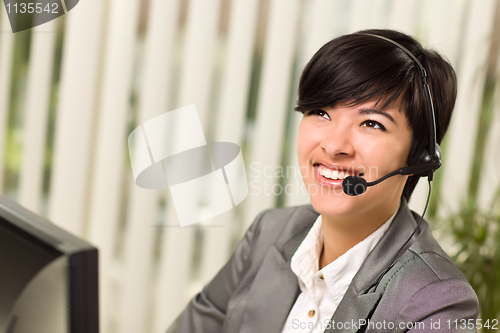 Image of Attractive Young Woman Smiles Wearing Headset