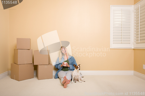 Image of Relaxing Woman and Dog Next to Boxes on Floor