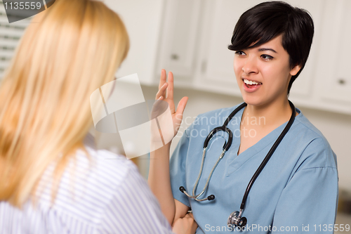 Image of Attractive Mixed Race Young Female Doctor Talking with Patient