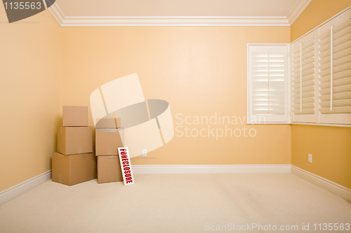 Image of Moving Boxes and Foreclosure Real Estate Sign on Floor in Empty 