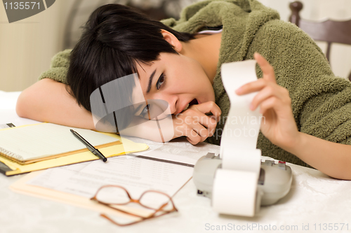 Image of Multi-ethnic Young Woman Agonizing Over Financial Calculations