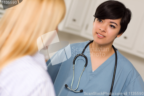 Image of Attractive Mixed Race Young Female Doctor Talking with Patient