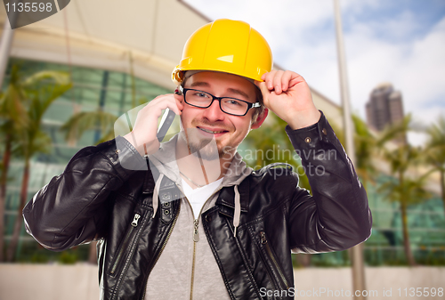 Image of Young Cunstruction Worker on Cell Phone In Front of Building