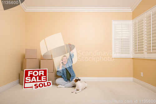 Image of Sold Real Estate Signs, Boxes and Happy Woman on Phone