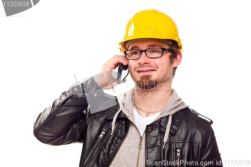 Image of Handsome Young Man in Hard Hat on Phone