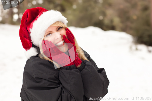 Image of Attractive Santa Hat Wearing Blond Woman Having Fun in Snow