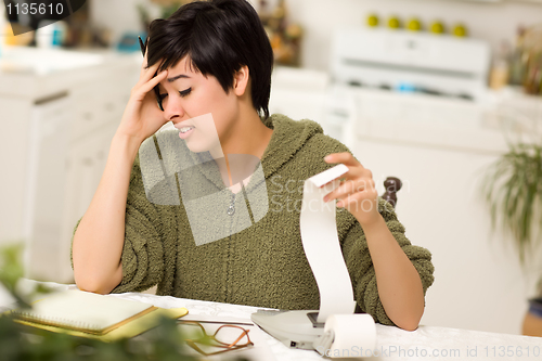 Image of Multi-ethnic Young Woman Agonizing Over Financial Calculations