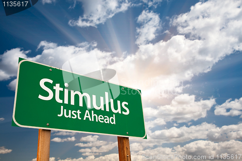 Image of Stimulus Green Road Sign and Clouds