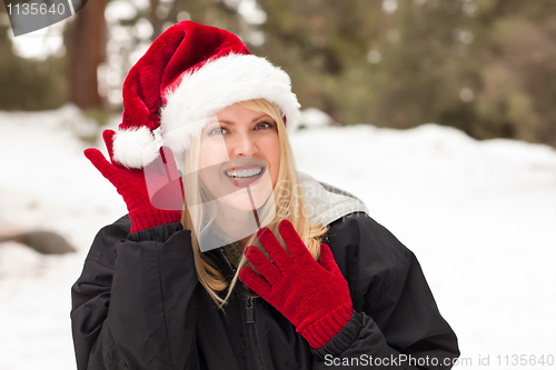 Image of Attractive Santa Hat Wearing Blond Woman Having Fun in Snow